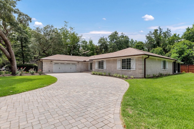 ranch-style home featuring a garage and a front yard