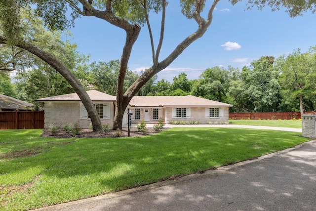 ranch-style home featuring a front lawn