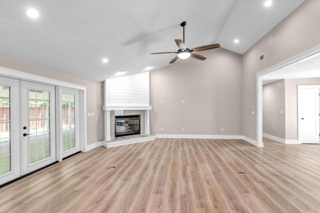 unfurnished living room featuring ceiling fan, light wood-type flooring, and lofted ceiling