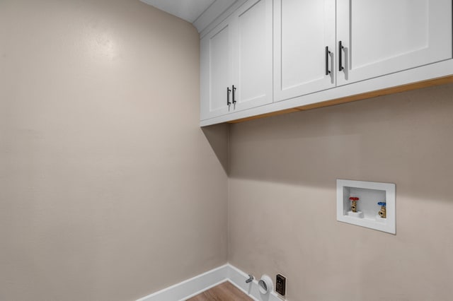 laundry room featuring cabinets, hookup for a gas dryer, hookup for a washing machine, hookup for an electric dryer, and light hardwood / wood-style floors