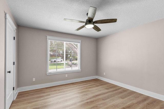 spare room featuring a textured ceiling, light hardwood / wood-style floors, and ceiling fan