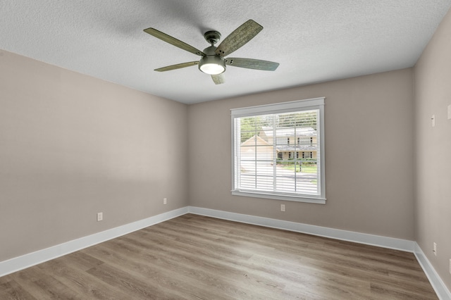 spare room featuring ceiling fan, a textured ceiling, and light hardwood / wood-style flooring