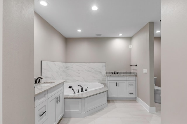 bathroom featuring vanity, toilet, and a bathtub