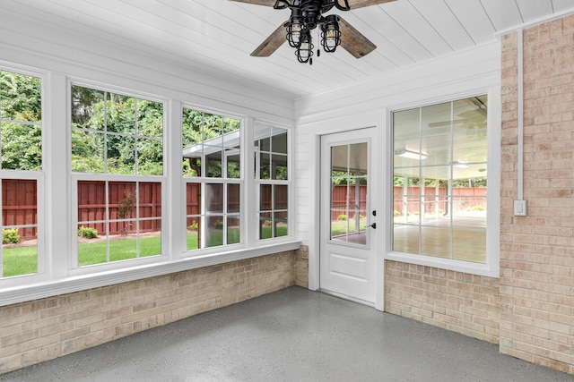 unfurnished sunroom featuring ceiling fan