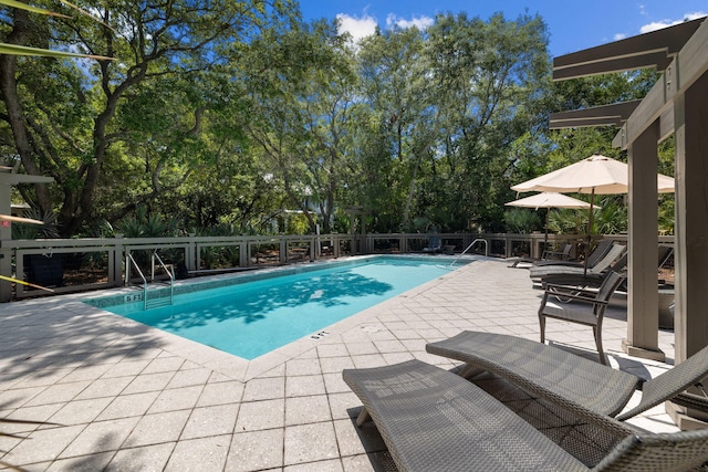 pool featuring a patio and fence