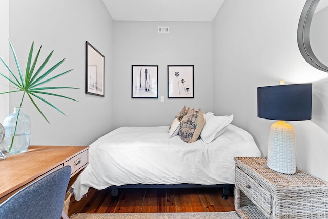 bedroom featuring visible vents and wood finished floors