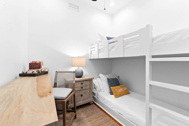 bedroom with wood finished floors and visible vents