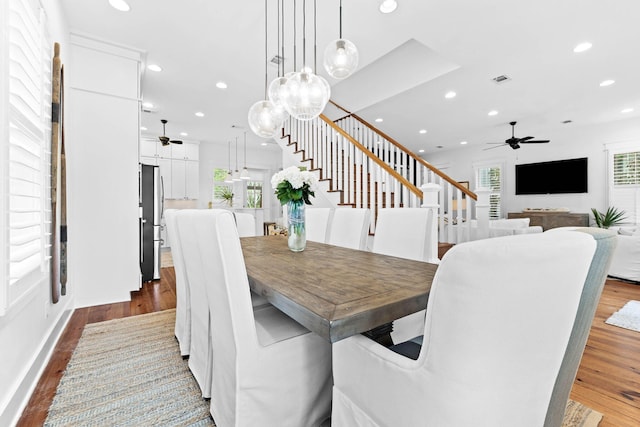 dining space featuring wood finished floors, stairway, recessed lighting, and ceiling fan