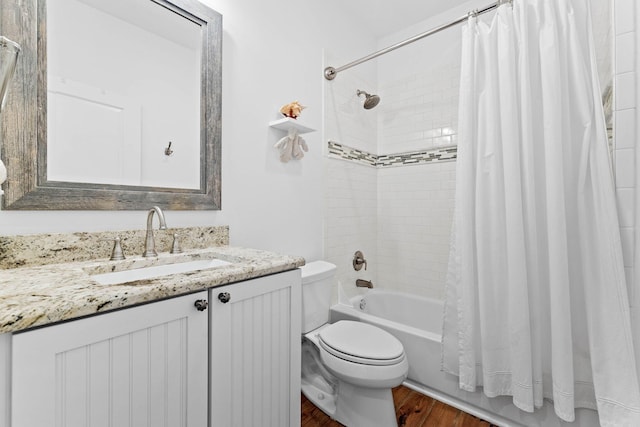 full bath with vanity, toilet, shower / tub combo, and wood finished floors