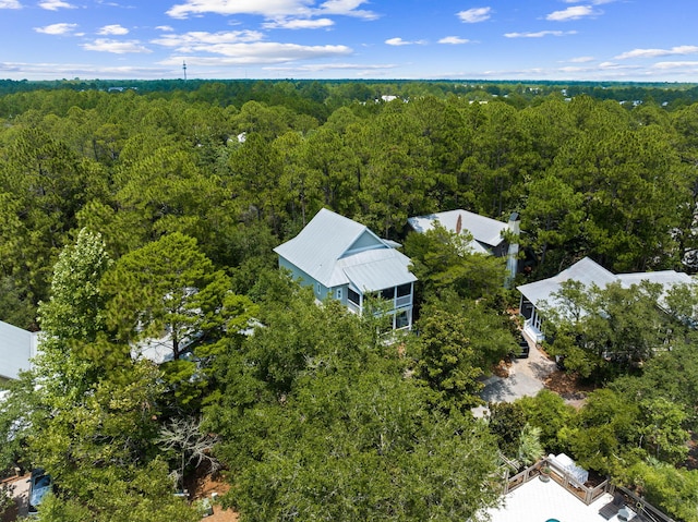 drone / aerial view featuring a wooded view