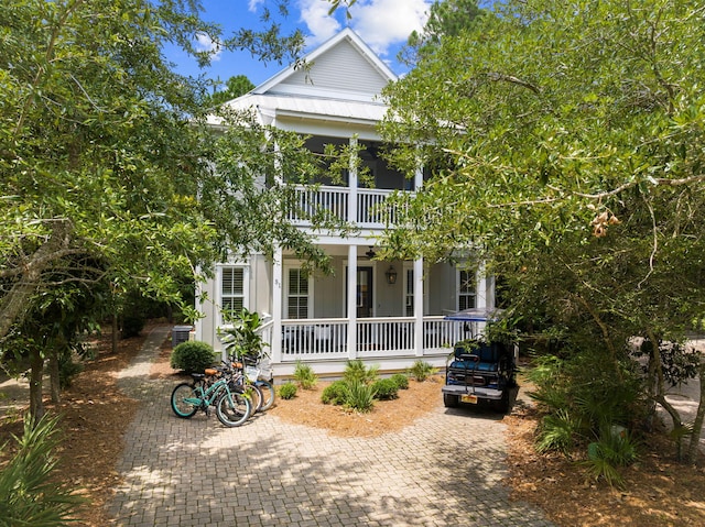 neoclassical / greek revival house with a balcony and covered porch