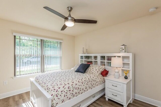 bedroom with ceiling fan and dark hardwood / wood-style floors