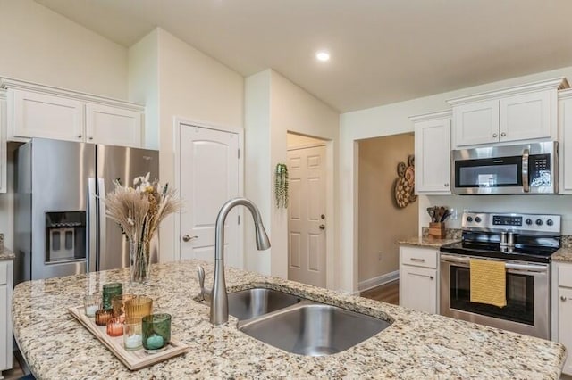 6022 Willsey Trl, Crestview, FL 32539 - kitchen featuring white cabinets, light stone countertops, appliances with stainless steel finishes, and a sink