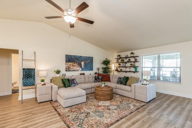 living room featuring high vaulted ceiling, ceiling fan, and light hardwood / wood-style floors