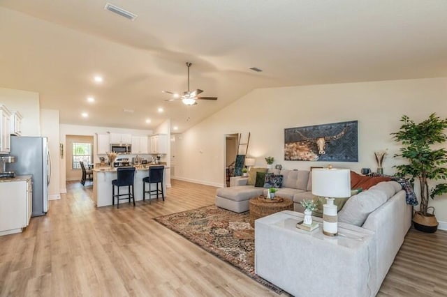 6022 Willsey Trl, Crestview, FL 32539 - living area featuring visible vents, light wood-style flooring, lofted ceiling, and a ceiling fan