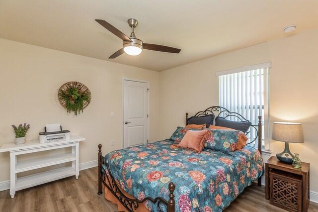 bedroom featuring ceiling fan and hardwood / wood-style flooring