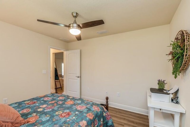 6022 Willsey Trl, Crestview, FL 32539 - bedroom with visible vents, baseboards, wood finished floors, and a ceiling fan