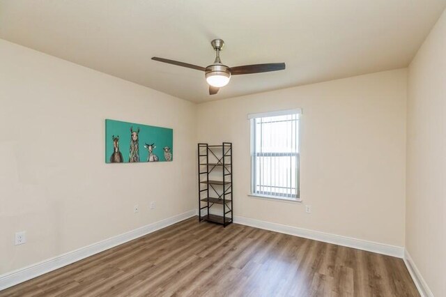 unfurnished room with ceiling fan and hardwood / wood-style floors