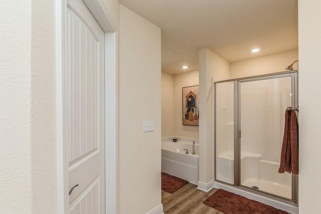 6022 Willsey Trl, Crestview, FL 32539 - bathroom featuring wood finished floors, baseboards, recessed lighting, a stall shower, and a garden tub