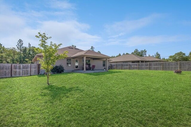 6022 Willsey Trl, Crestview, FL 32539 - rear view of property with a yard, a patio, and a fenced backyard