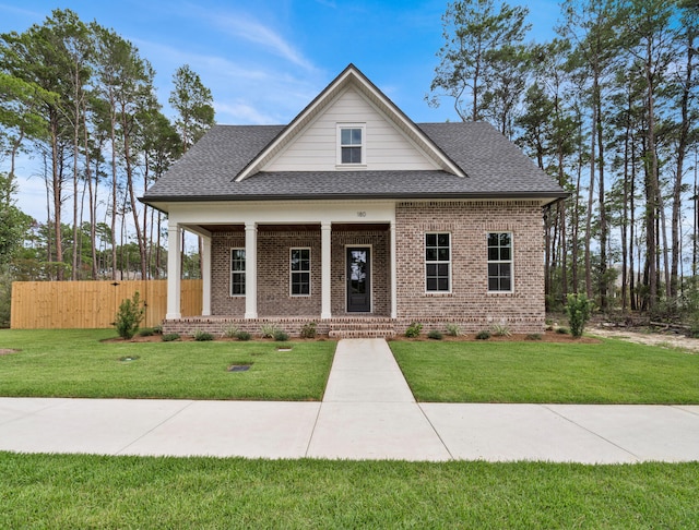 view of front of home with a front lawn and covered porch