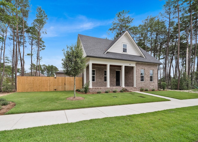 view of front of house featuring a front yard and covered porch