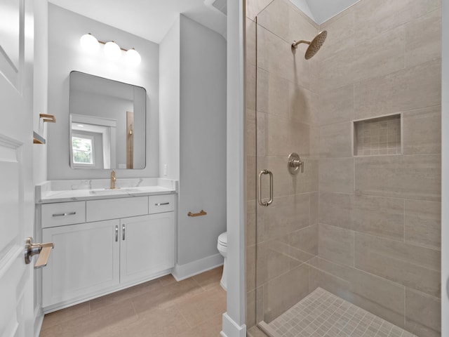 bathroom featuring vanity, toilet, tile patterned floors, and an enclosed shower