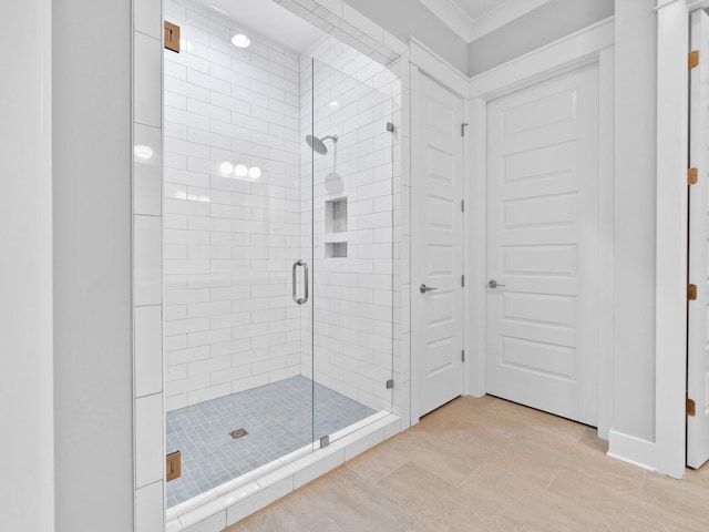 bathroom with a shower with door