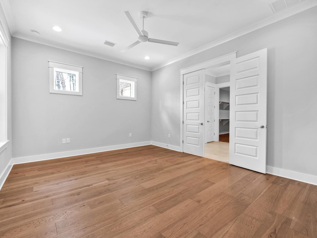 unfurnished bedroom featuring ceiling fan, a closet, light hardwood / wood-style flooring, and ornamental molding