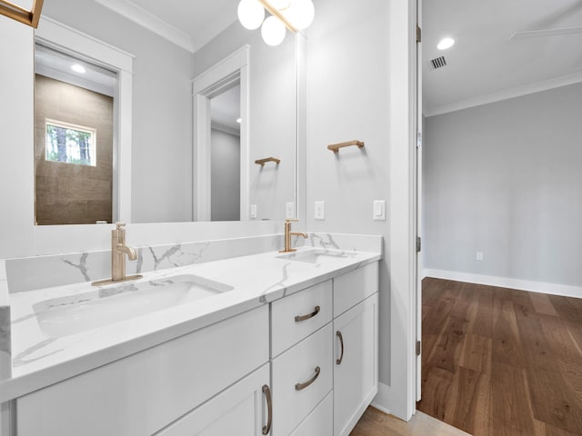 bathroom featuring wood-type flooring, vanity, and crown molding