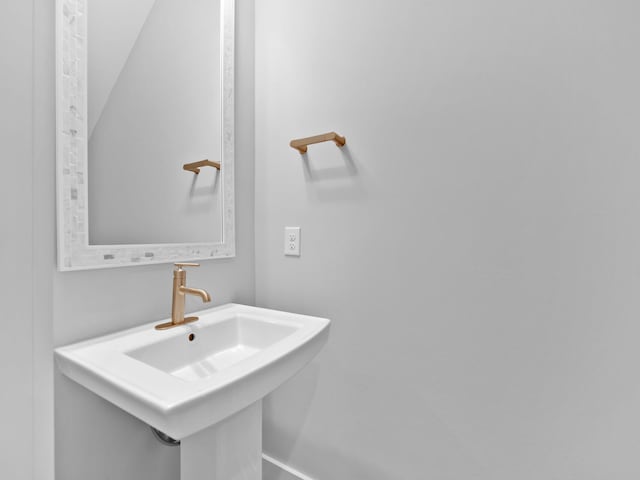 bathroom with vaulted ceiling and sink