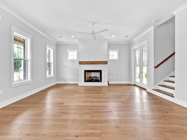 unfurnished living room with a fireplace, ornamental molding, ceiling fan, and light hardwood / wood-style flooring