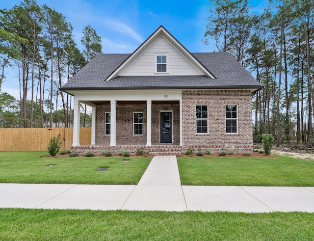 view of front of home featuring covered porch and a front yard