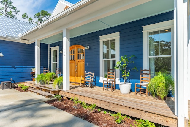 view of exterior entry with a porch