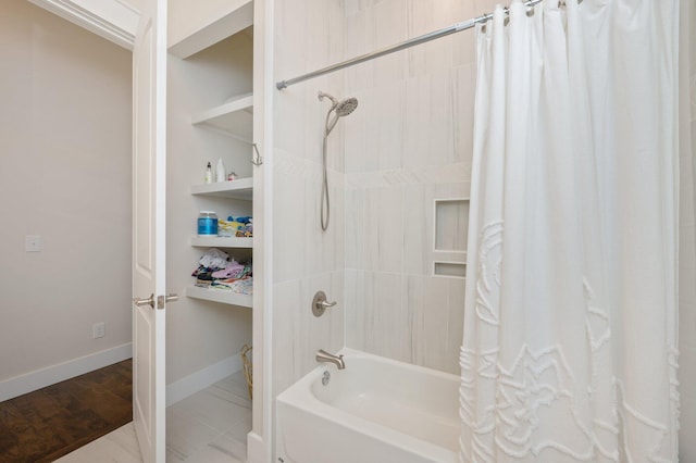 bathroom featuring shower / bath combination with curtain and baseboards