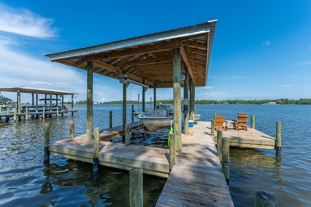 dock area with a water view and boat lift