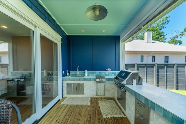 view of patio / terrace with an outdoor kitchen, grilling area, a sink, and a ceiling fan