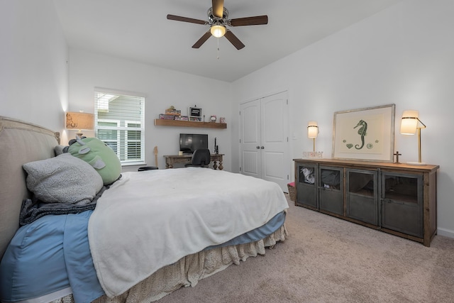 carpeted bedroom featuring ceiling fan and a closet