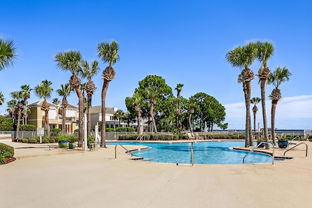 pool featuring a patio area and fence