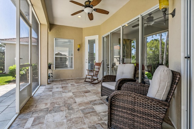 sunroom featuring plenty of natural light and ceiling fan