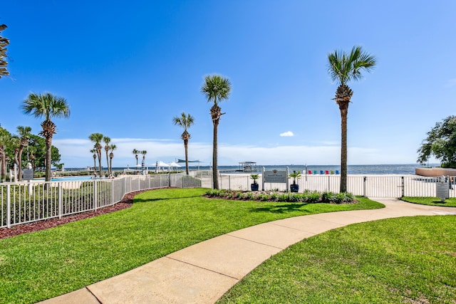 exterior space featuring a water view and fence