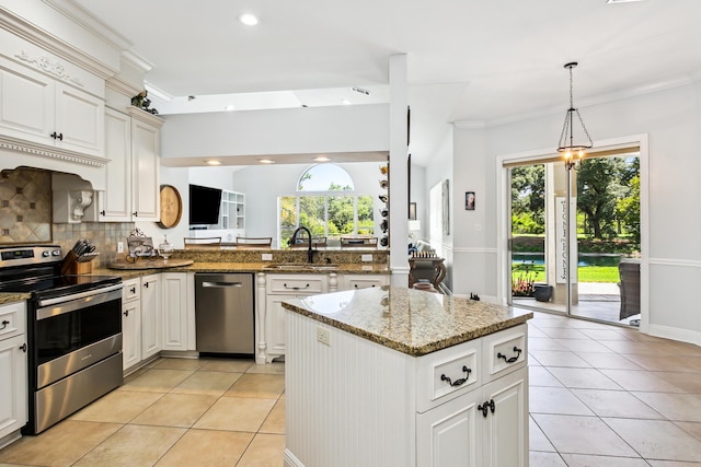 kitchen with stainless steel appliances, a kitchen island, a sink, and light tile patterned floors