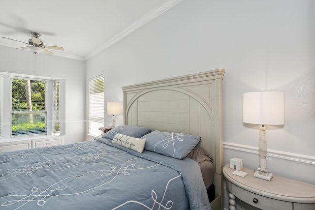 bedroom with ceiling fan and crown molding