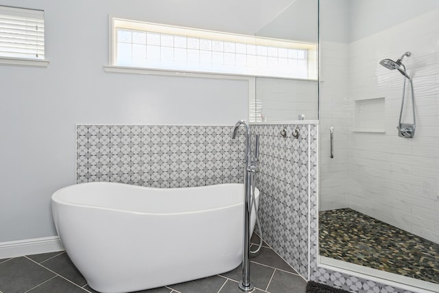 full bathroom featuring a stall shower, a soaking tub, tile patterned flooring, and a wealth of natural light