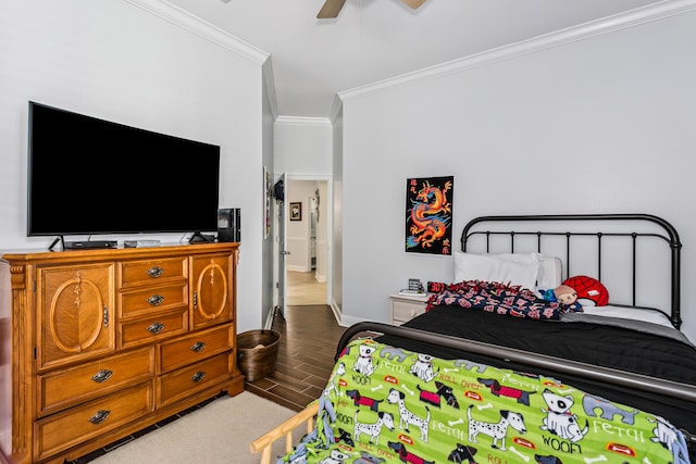 bedroom featuring baseboards, ornamental molding, a ceiling fan, and wood finished floors