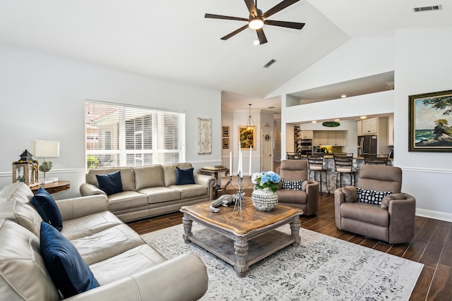 living room with high vaulted ceiling, dark wood-style flooring, visible vents, and ceiling fan