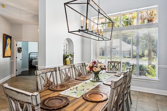 dining room with baseboards, a notable chandelier, and tile patterned floors