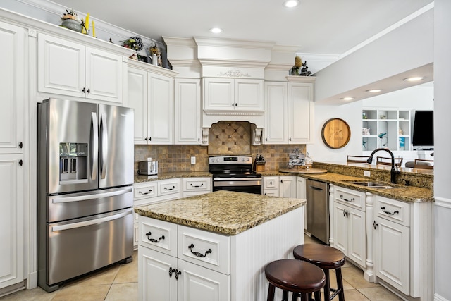 kitchen featuring appliances with stainless steel finishes, backsplash, light tile patterned flooring, and a sink