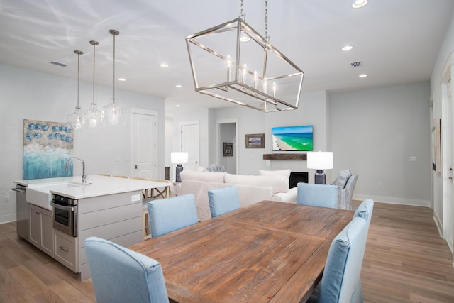 dining space featuring sink and light hardwood / wood-style floors