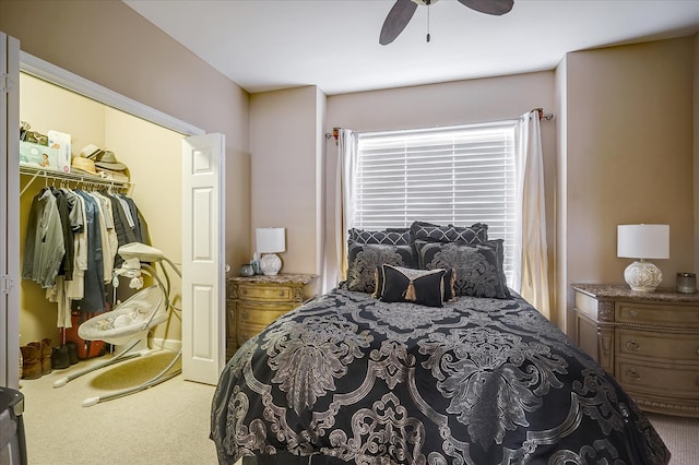 carpeted bedroom featuring ceiling fan, a closet, multiple windows, and a spacious closet